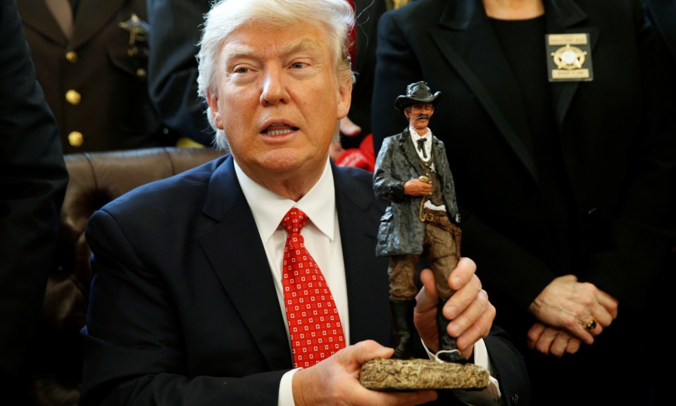 President Trump hods small statue of a sherrif from the early 20th century