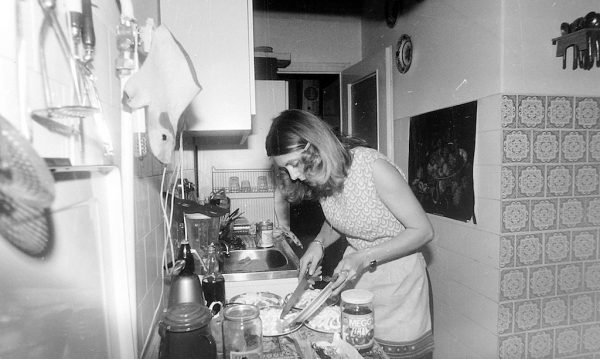 woman cooking in cramped kitchen